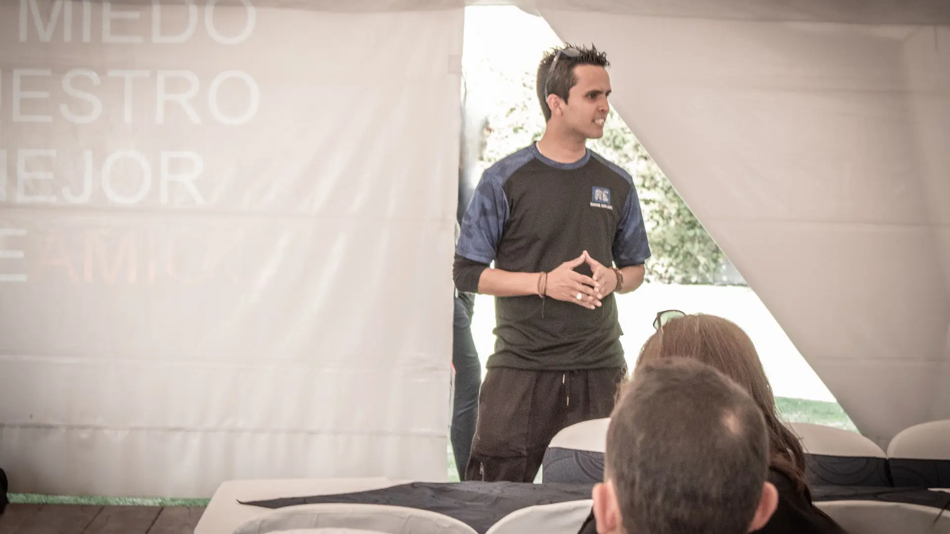Xavi Larco speaking to an audience at an immersive event